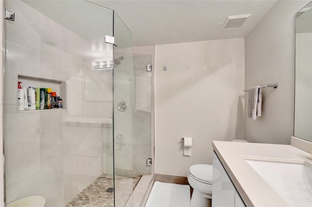 full bathroom with toilet, a stall shower, visible vents, and vanity