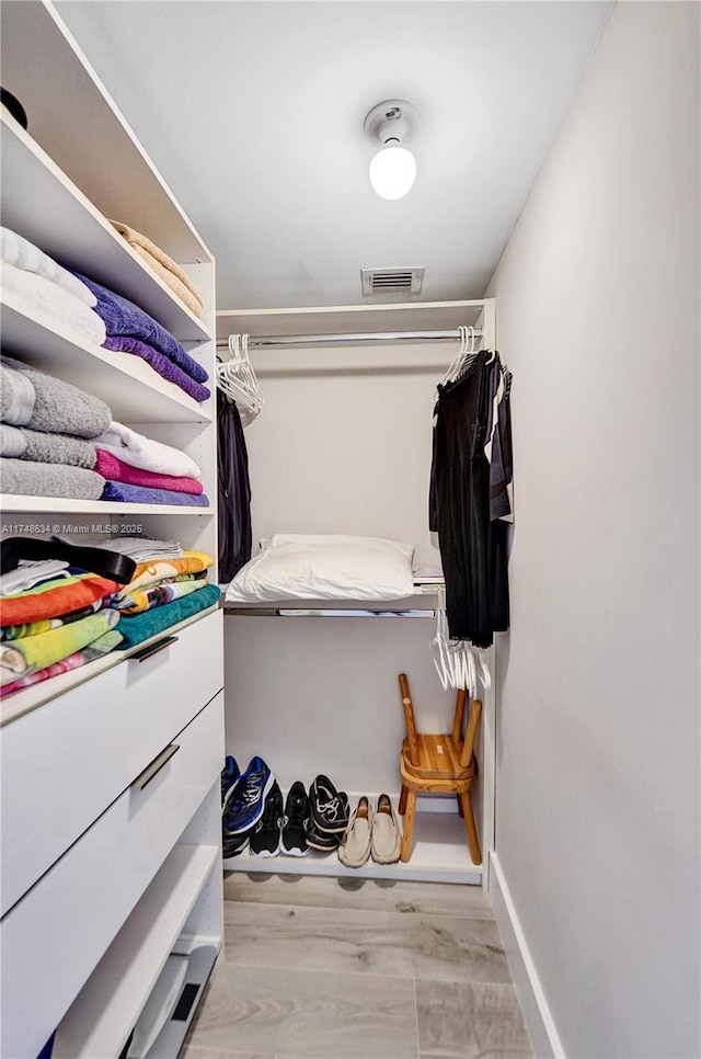 spacious closet featuring light wood-type flooring and visible vents