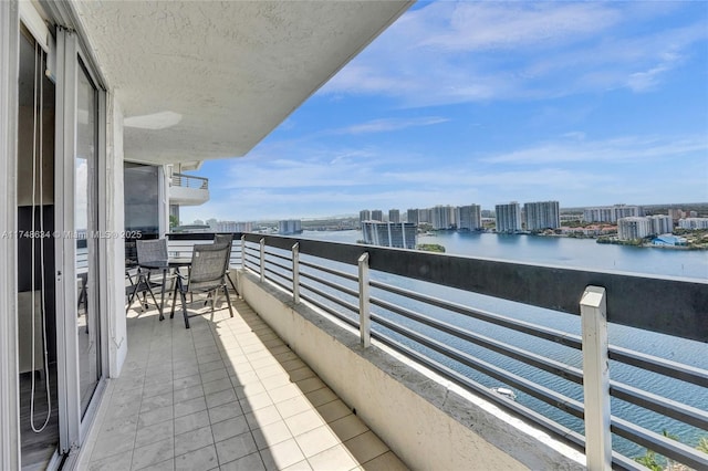 balcony featuring a view of city and a water view