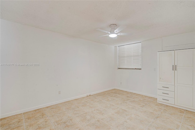 unfurnished bedroom featuring ceiling fan, baseboards, and a textured ceiling