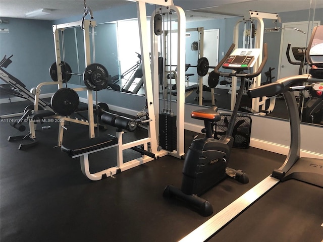 workout area featuring baseboards