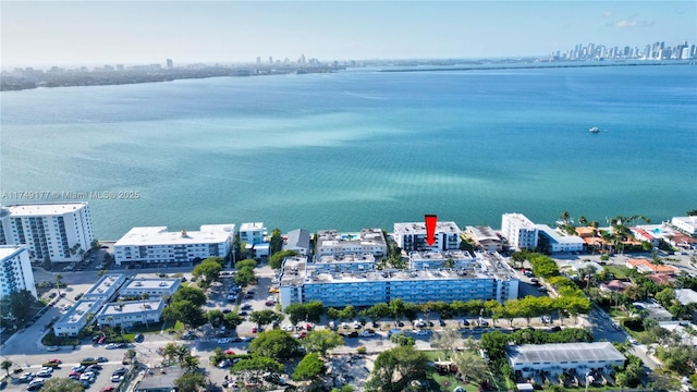 birds eye view of property with a water view and a city view