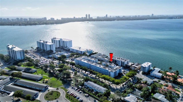 birds eye view of property with a view of city and a water view