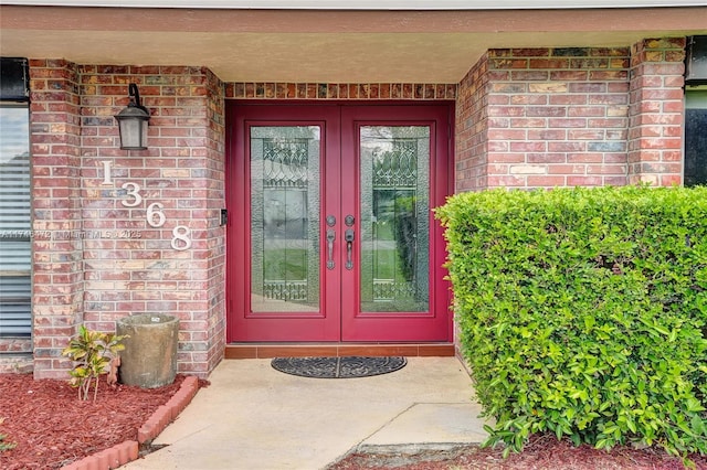 doorway to property with brick siding and french doors