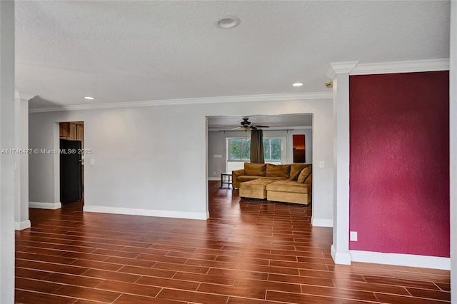 living area featuring ornamental molding, baseboards, and wood finished floors