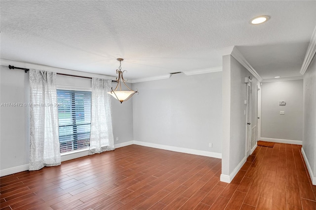 unfurnished room featuring a textured ceiling, baseboards, and wood finished floors