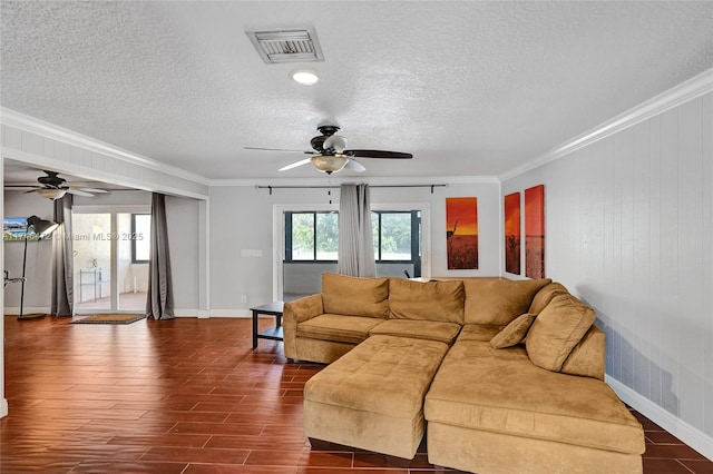 living area featuring dark wood-style floors, visible vents, a textured ceiling, and crown molding