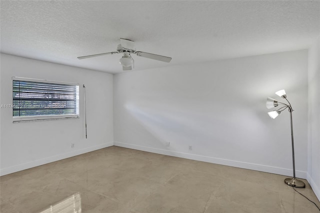 unfurnished room featuring ceiling fan, a textured ceiling, and baseboards