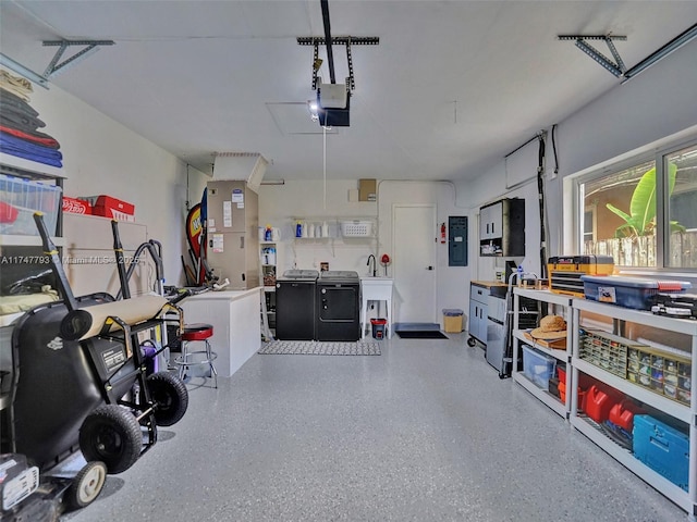 3204 Robbins Rd, Pompano Beach, FL 33062 - garage featuring washer and dryer, heating unit, electric panel, and a garage door opener