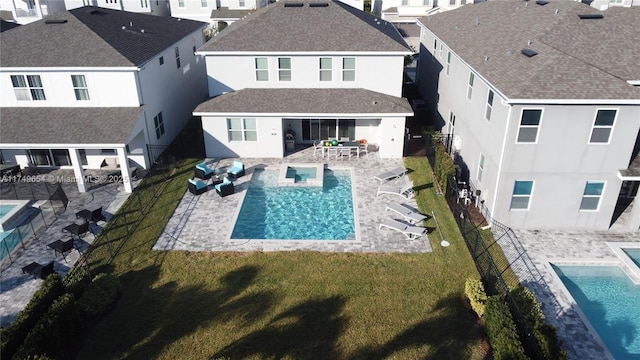 exterior space featuring a patio, stucco siding, a lawn, a residential view, and a fenced backyard