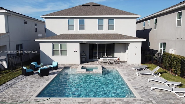 rear view of house featuring a patio, a fenced backyard, and stucco siding