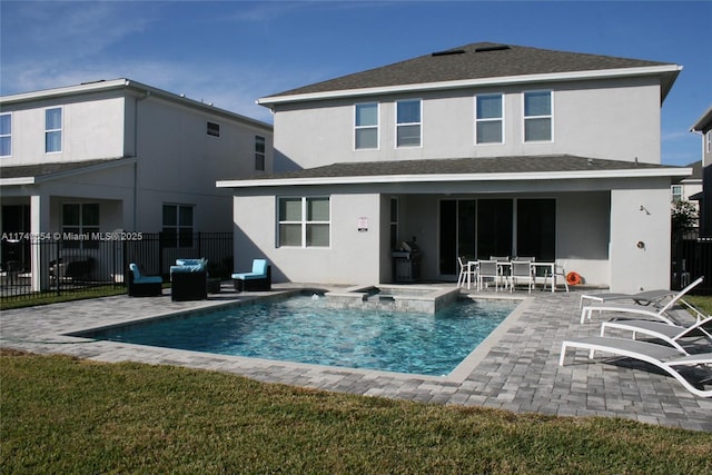 back of house featuring a fenced in pool, a patio area, fence, and stucco siding