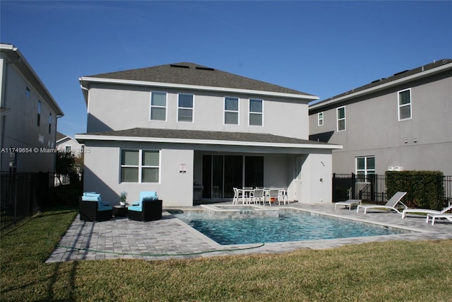 back of house with a yard, a patio area, fence, and stucco siding