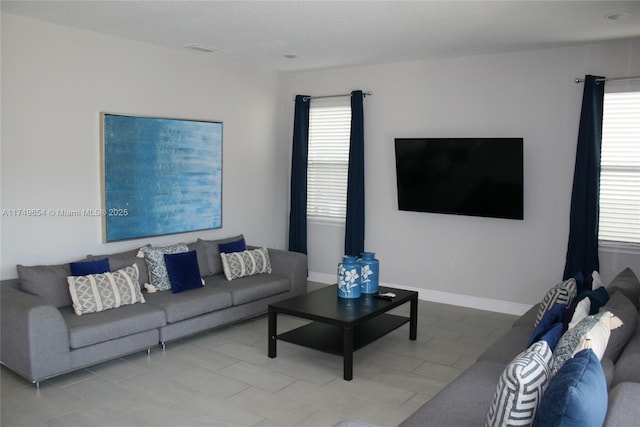 living area featuring baseboards and a wealth of natural light