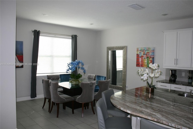 dining area with visible vents, baseboards, and light tile patterned floors