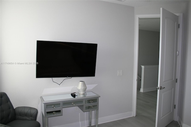 interior space featuring wood finished floors and baseboards