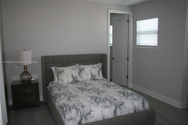 bedroom featuring dark wood-style floors and baseboards