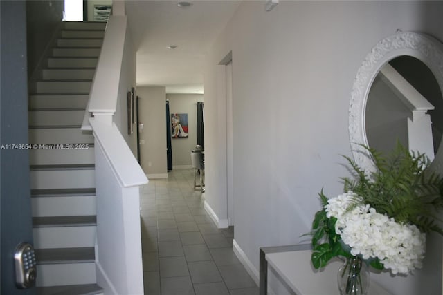 staircase with tile patterned flooring and baseboards