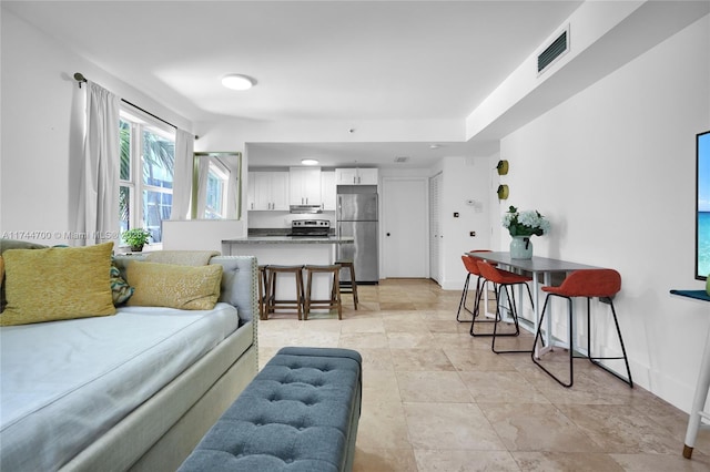 living area featuring visible vents and baseboards