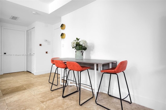 dining room featuring visible vents and baseboards