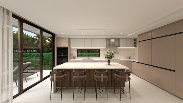 kitchen featuring wall chimney exhaust hood, modern cabinets, a kitchen island, light countertops, and gray cabinetry