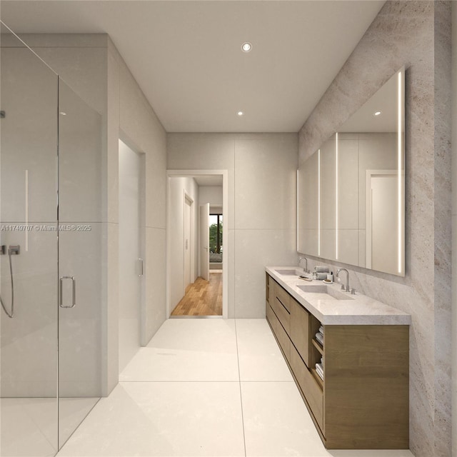 bathroom featuring a stall shower, tile patterned floors, a sink, and double vanity