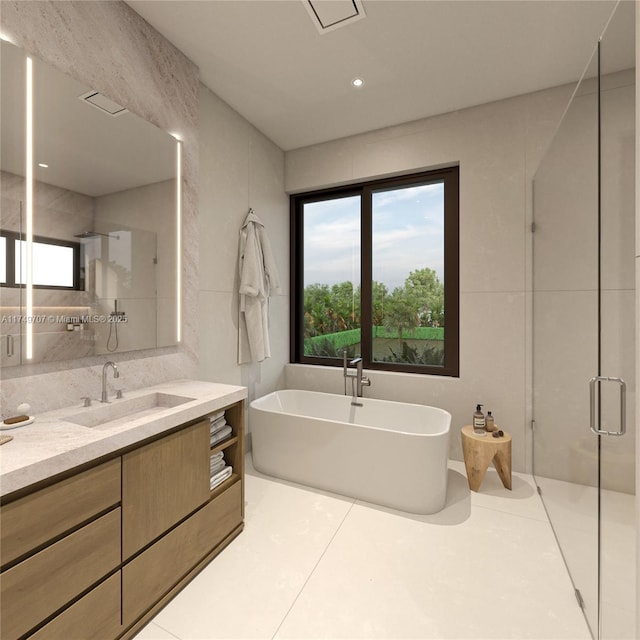 full bathroom with a wealth of natural light, a soaking tub, a shower stall, and vanity