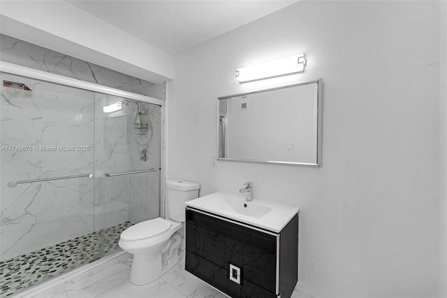 bathroom featuring toilet, marble finish floor, a marble finish shower, and vanity