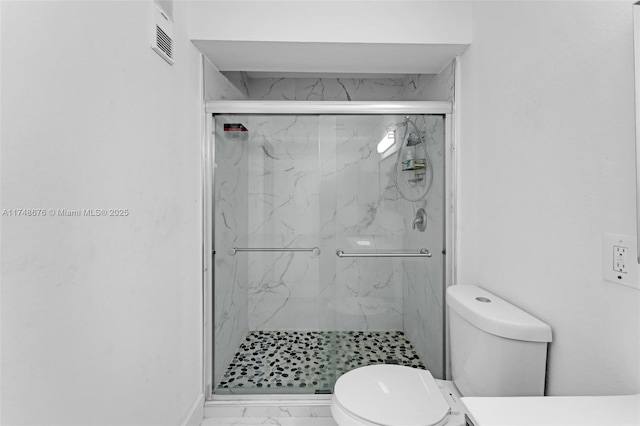 full bath featuring toilet, marble finish floor, a marble finish shower, and visible vents