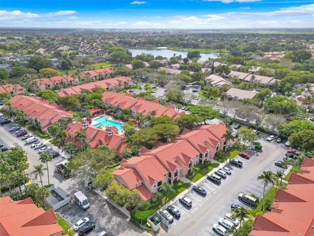 drone / aerial view featuring a residential view and a water view