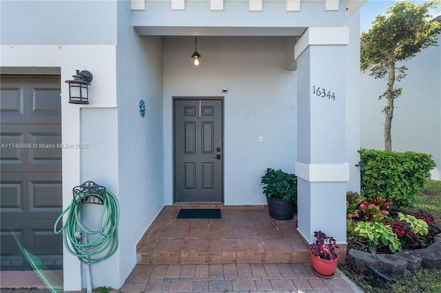 property entrance featuring stucco siding