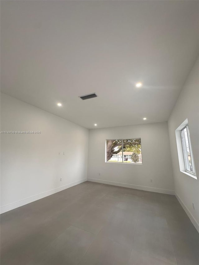 spare room featuring recessed lighting, visible vents, plenty of natural light, and baseboards