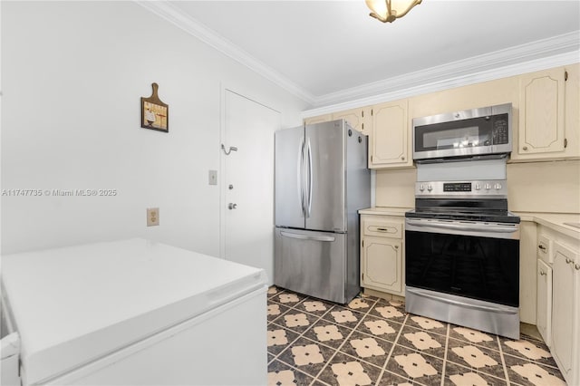 kitchen featuring appliances with stainless steel finishes, light countertops, and cream cabinetry