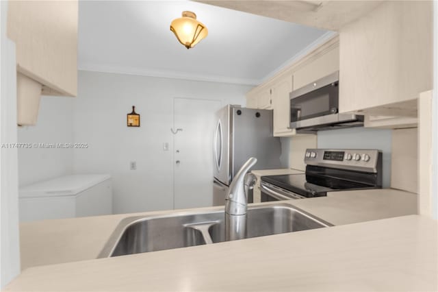 kitchen with a sink, crown molding, stainless steel appliances, and light countertops