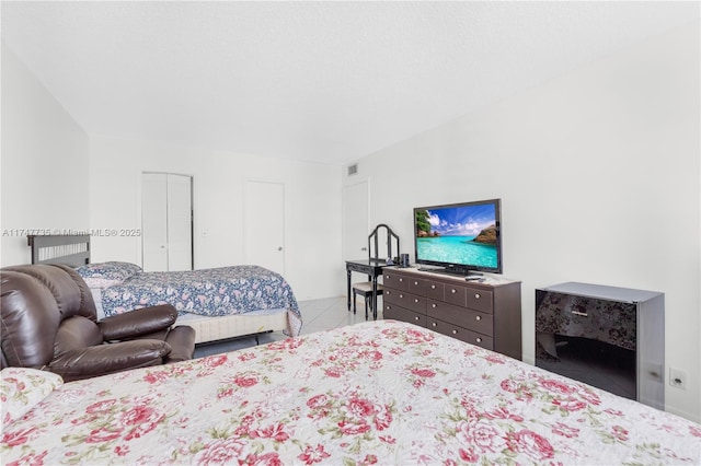 bedroom with visible vents and light tile patterned floors