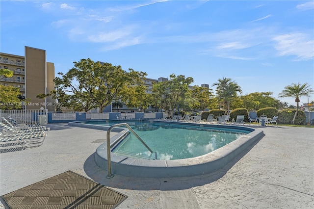 community pool featuring a patio area and fence