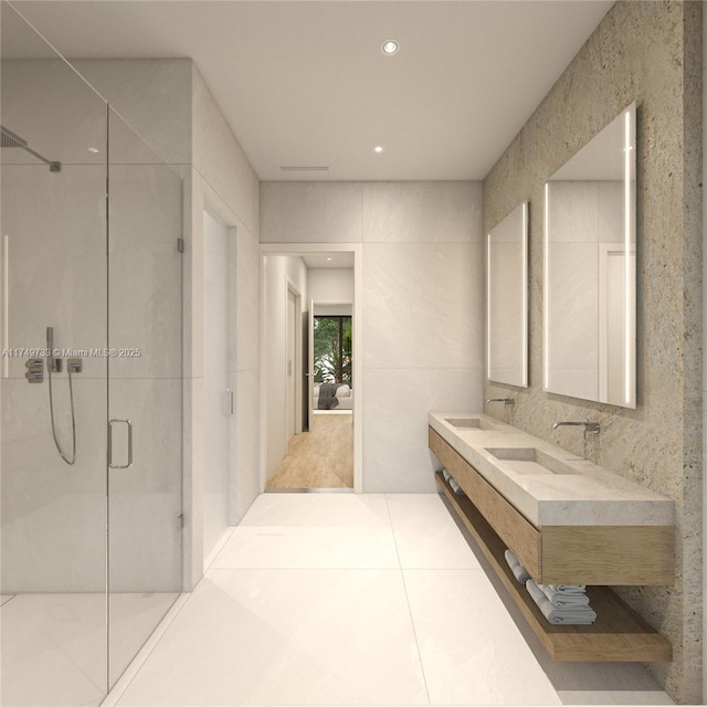 bathroom featuring double vanity, recessed lighting, a stall shower, a sink, and tile patterned flooring