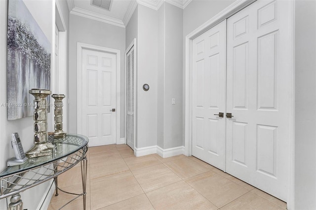 interior space featuring visible vents, crown molding, baseboards, and light tile patterned floors