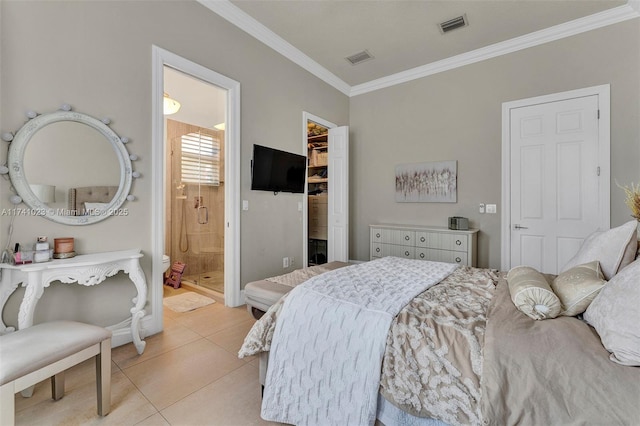 bedroom with visible vents, a walk in closet, crown molding, and light tile patterned flooring