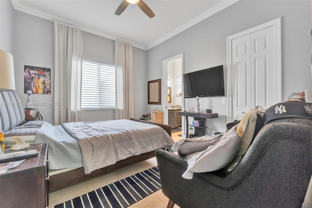 bedroom featuring ornamental molding, light tile patterned flooring, ensuite bath, and a ceiling fan