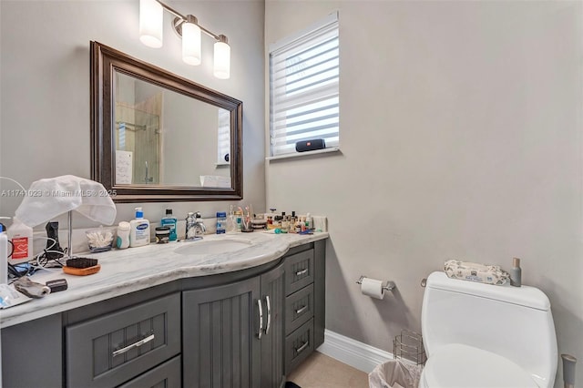 full bathroom with toilet, baseboards, and vanity