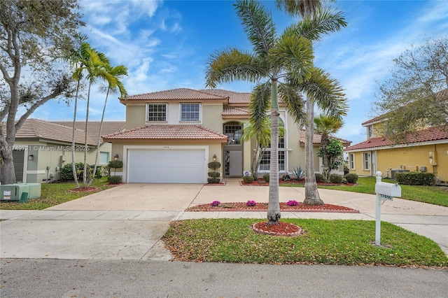 view of front facade featuring stucco siding, concrete driveway, an attached garage, a tiled roof, and a front lawn