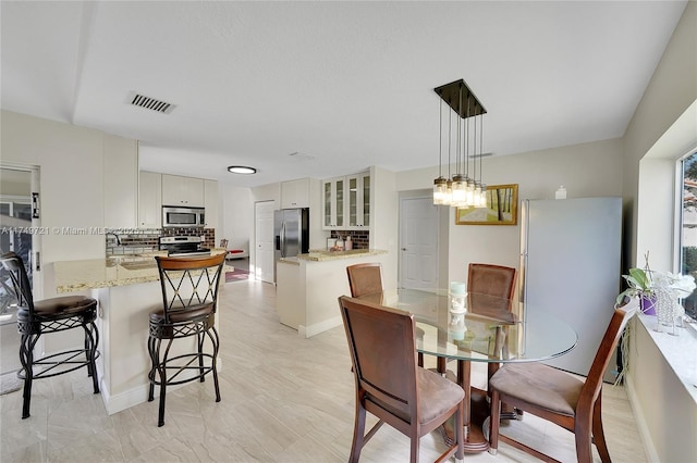 dining space featuring visible vents