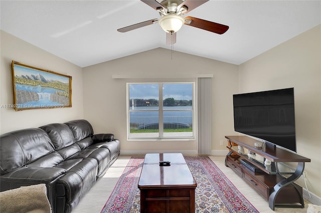 living area with vaulted ceiling, ceiling fan, light wood finished floors, and baseboards