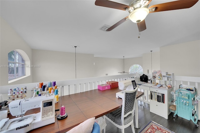 recreation room with ceiling fan, visible vents, and dark wood finished floors