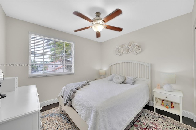 bedroom with baseboards, a ceiling fan, and wood finished floors