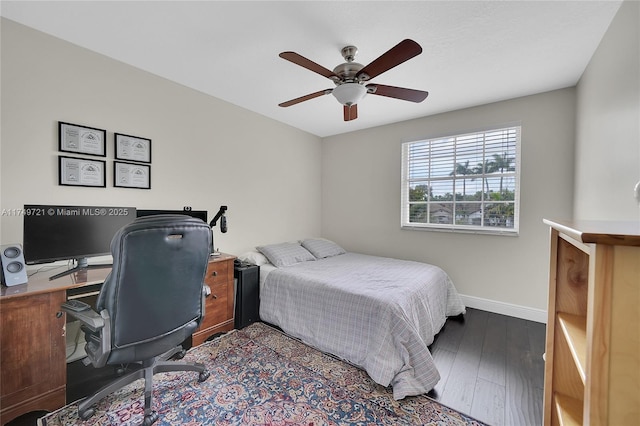 bedroom with ceiling fan, wood finished floors, and baseboards