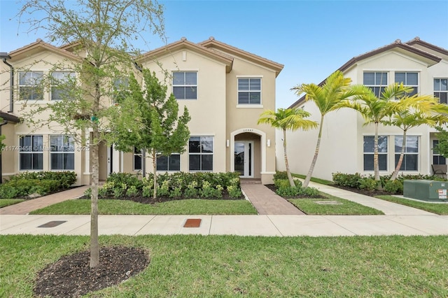 view of front of house with a front lawn and stucco siding