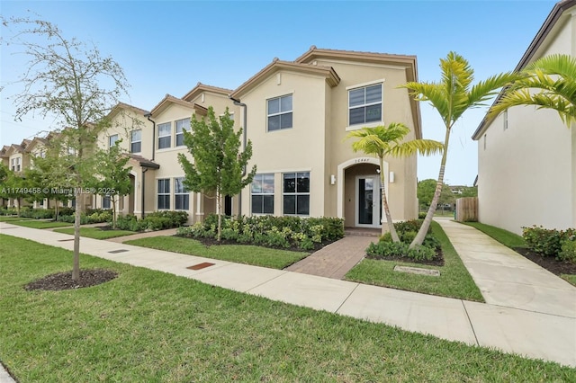 view of front facade featuring a front lawn and stucco siding