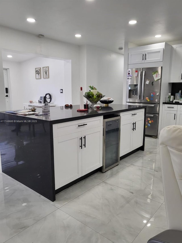 kitchen with dark countertops, beverage cooler, white cabinets, and stainless steel fridge with ice dispenser